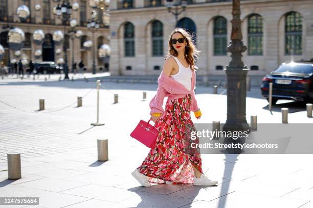 Alexandra Lapp is seen wearing CAMOUFLAGE COUTURE skirt and knit, CELINE tank top, CELINE trainer low lace-up sneaker, CHANEL sunglasses, HERMES mini...