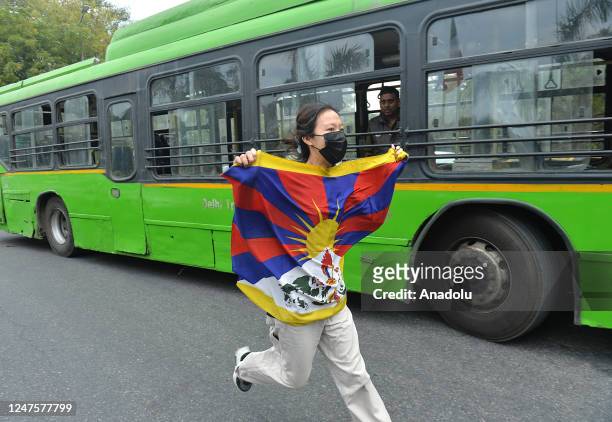 Tibetan exile activist holds a flag during a protest against the visit of Chinese Foreign Minister Qin Gang The Qin is visiting India to attend the...