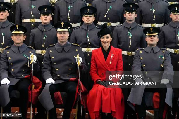 Britain's Prince William, Prince of Wales, and Britain's Catherine, Princess of Wales, sit for an official photo with The Prince of Wales' company...