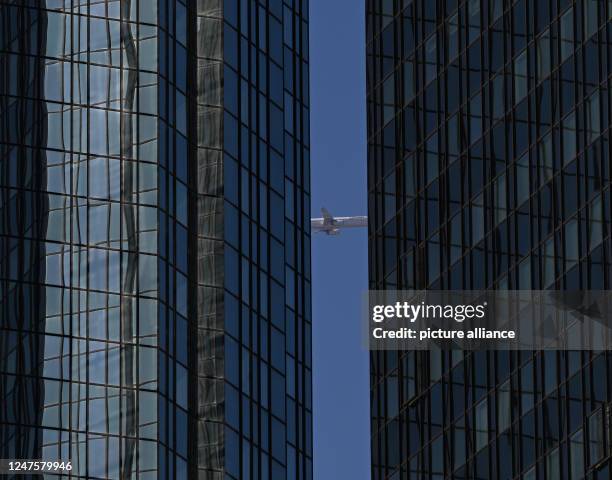 March 2023, Hesse, Frankfurt/Main: After taking off from Frankfurt Airport, a Lufthansa passenger plane can be seen between the twin towers of...