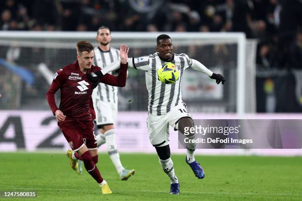 Ivan Ilic of Torino Fc and Paul Pogba of Juventus FC battle for the ball during the Serie A match between Juventus and Torino FC at Allianz Stadium...
