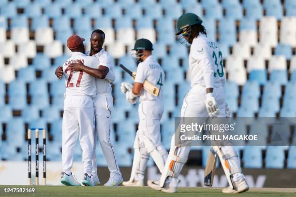 West Indies' Kemar Roach celebrates after the dismissal of South Africa's Tony de Zorzi during the second day of the first Test cricket match between...