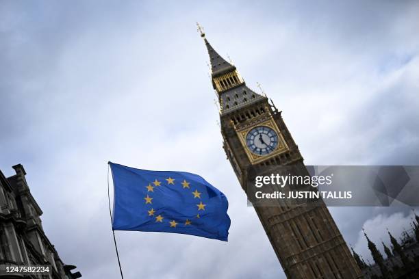 An EU flag, flown by anti-Conservative and anti-Brexit activists, flaps in wind, in front of the Elizabeth Tower, commonly known by the name of the...