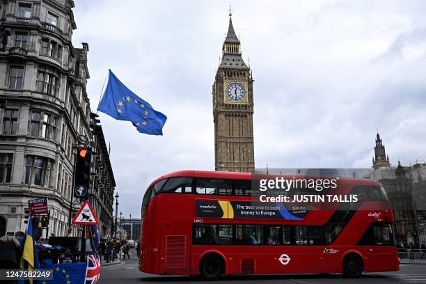 An EU flag, flown by anti-Conservative and anti-Brexit activists, flaps in the air in front of the Elizabeth Tower, commonly known by the name of the...