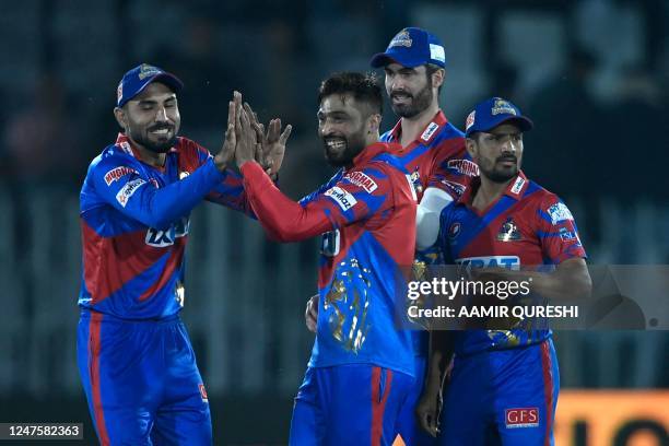 Karachi Kings' Mohammad Amir celebrates after taking the wicket of Peshawar Zalmi's Saim Ayub during the Pakistan Super League T20 cricket match...