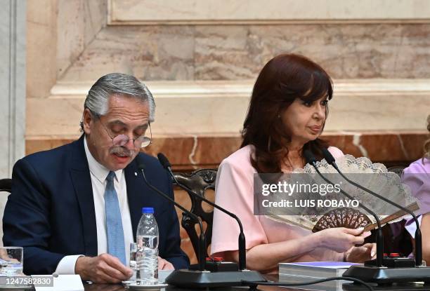 Argentina's President Alberto Fernandez delivers a speech as Vice-President Cristina Fernandez de Kirchner uses a hand fan during the opening of the...