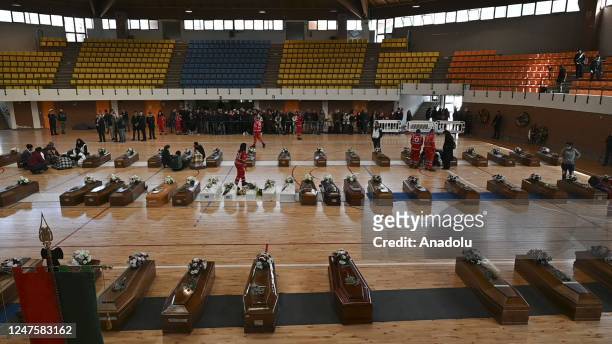 Relatives of people who died in a migrant shipwreck, pay tribute on coffins at sports hall morgue in Crotone, Italy on March 01, 2023. The morgue...