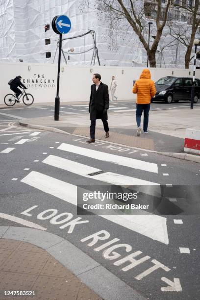 With the former US Embassy being refevloped into a luxury property in the background, pedestrians cross the road on a zebra crossing in Grosvenor...