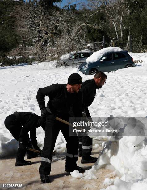 March 2023, Spain, Escora: Members of the Military Emergency Unit UME shovel snow in the Escora pilgrimage site in front of the monastery of Lluc....