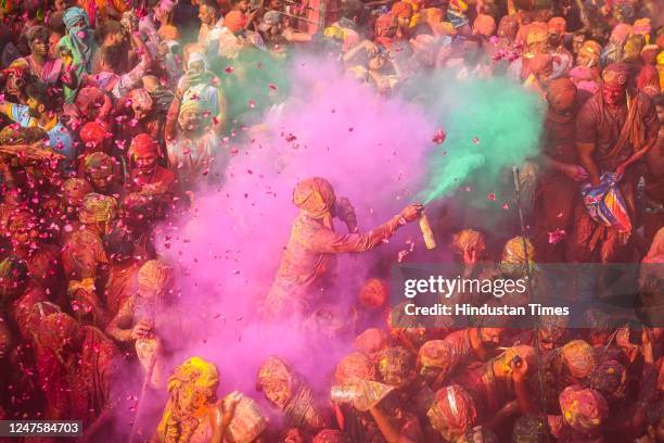 People smear each-other with coloured powder during the Lathmar Holi festival, at Nandji Temple on March 1, 2023 in Mathura, India. The lathmar Holi...