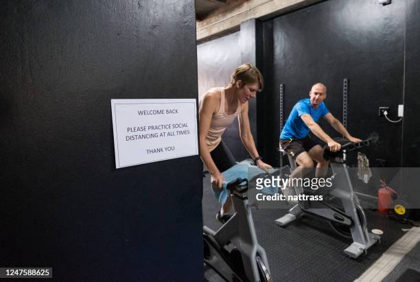 covid signage in a gym warning clients of social distancing - hotel reopening stock pictures, royalty-free photos & images