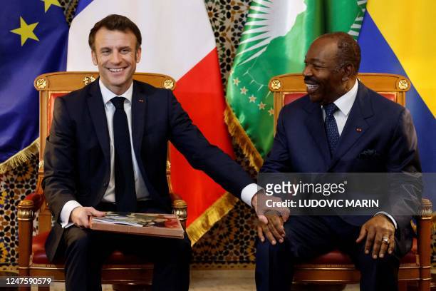 French President Emmanuel Macron meets with Gabon's President Ali Bongo Ondimba for a bilateral meeting at Presidential Palace in Libreville, on...