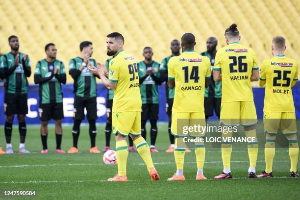 Players hold a minute of silence to pay tribute to late French football player Just Fontaine prior to the French Cup quarter-final football match...