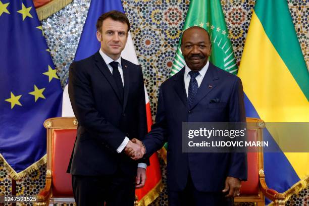 French President Emmanuel Macron shakes hands with Gabon's President Ali Bongo Ondimba during a bilateral meeting at Presidential Palace in...