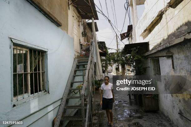 Lebanese Armenian girl walks at an alley in the Armenian refugees camp of Sanjak, part of which has been transformed into a parking lot, in the...