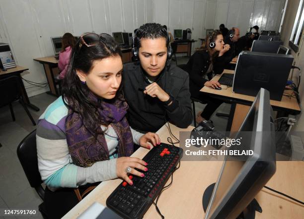 Young students use facebook in an Internet center on March 13, 2012 in Tunis. Today, Tunisia celebrates the first national day of Internet. The use...