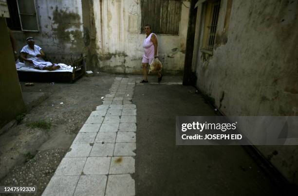 Lebanese Armenian woman walks through an alley in the Armenian refugees camp of Sanjak, part of which has been transformed into a parking lot, in the...