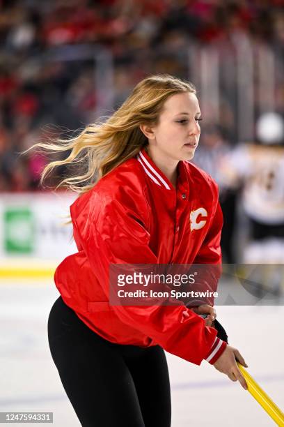 Calgary Flames ice girl cleans the ice during the second period of an NHL game between the Calgary Flames and the Boston Bruins on February 28 at the...