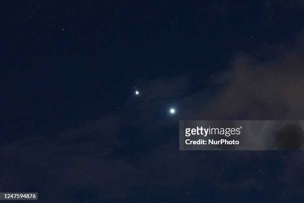 Planets Jupiter and Venus in conjunction are seen after sunset above LAquila, Italy, on march 1st, 2023. Planets seem to be very close . Moons of...