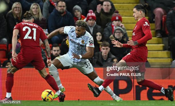 Liverpool's Greek defender Kostas Tsimikas vies with Wolverhampton Wanderers' Spanish midfielder Adama Traore during the English Premier League...