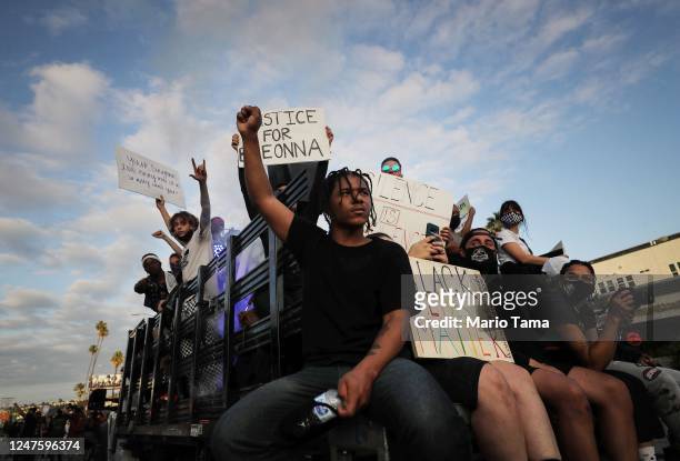 Protesters ride in a vehicle during a march on Hollywood Boulevard in a peaceful demonstration against racism and police brutality on June 06, 2020...
