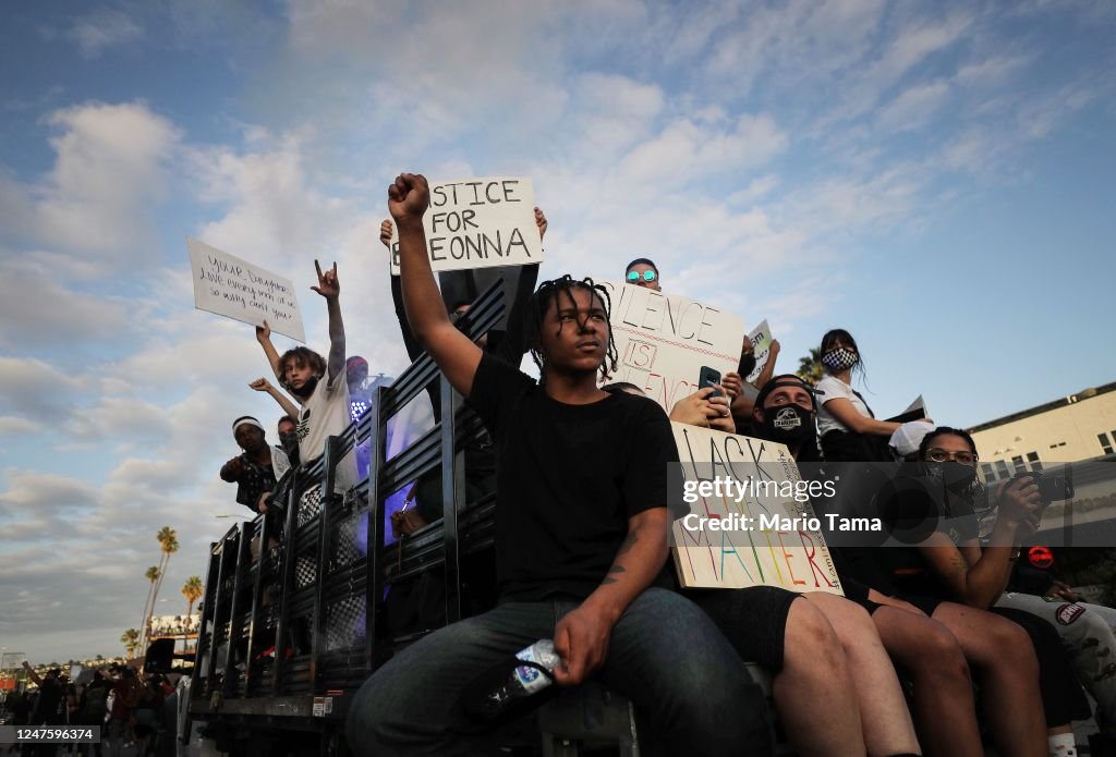 Stop Racism Protest Protesters ride in a vehicle during a march on Hollywood Boulevard in ...