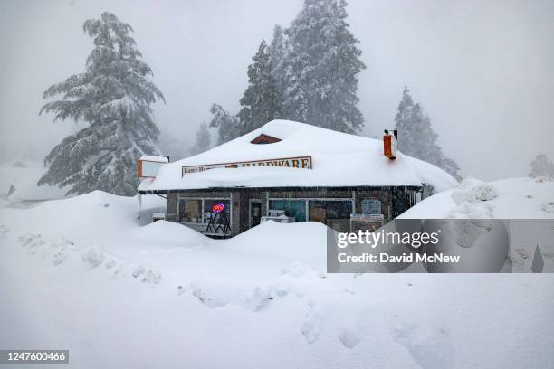 The open sign is still on at a business nevertheless shut down by the weather as residents throughout the San Bernardino Mountains remain trapped in...