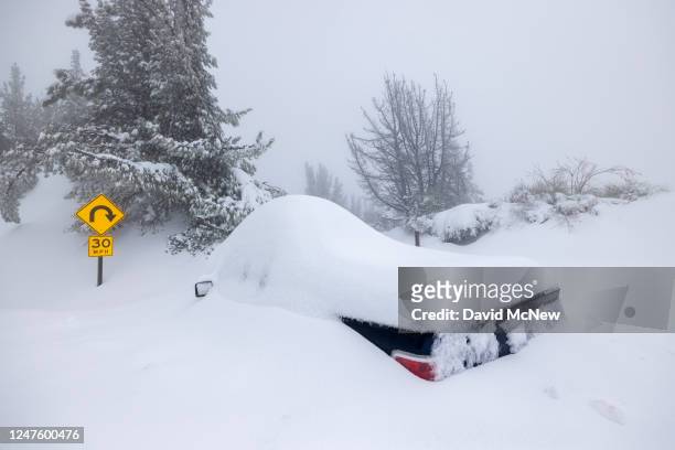 Vehicle is abandoned along a highway as residents throughout the San Bernardino Mountains remain trapped in their homes on March 1, 2023 near Running...