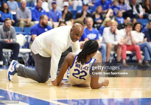 Kentucky Wildcats guard Cason Wallace is treated by a Kentucky Wildcats training staff member in a game between the Vanderbilt Commodores and the...