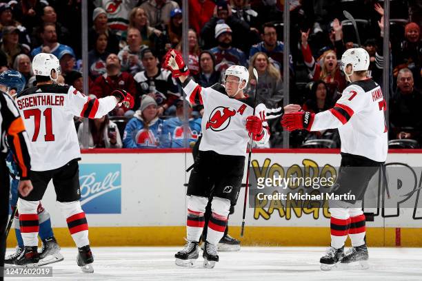 Jonas Siegenthaler, Ondrej Palat and Dougie Hamilton of the New Jersey Devils celebrate a goal against the Colorado Avalanche at Ball Arena on March...