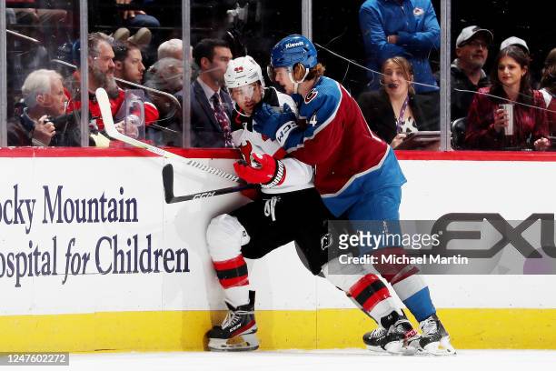 Bowen Byram of the Colorado Avalanche collides with Miles Wood of the New Jersey Devils at Ball Arena on March 1, 2023 in Denver, Colorado.