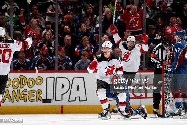 Michael McLeod, Nathan Bastian and Miles Wood of the New Jersey Devils celebrate a goal against the Colorado Avalanche at Ball Arena on March 1, 2022...
