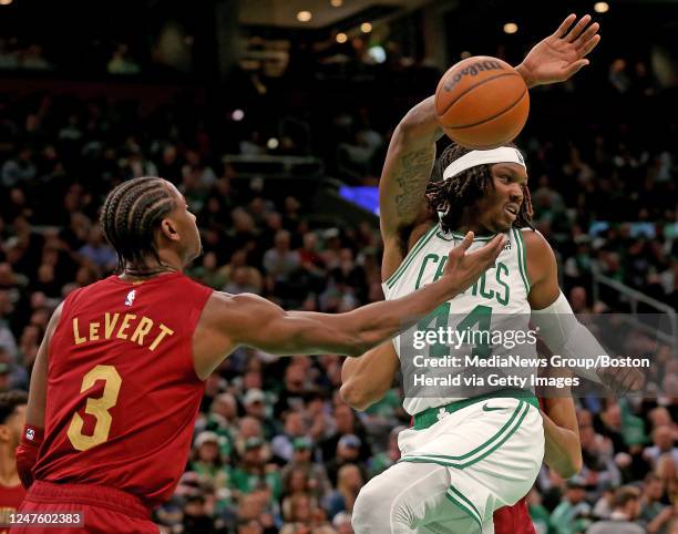 Robert Williams III of the Boston Celtics gets two points as Caris LeVert of the Cleveland Cavaliers rebounds during the first half of the NBA game...