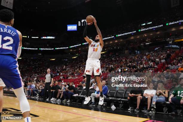 Caleb Martin of the Miami Heat shoots a three point basket during the game against the Philadelphia 76ers on March 1, 2023 at Miami-Dade Arena in...