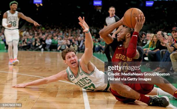 Mike Muscala of the Boston Celtics tries to stop Darius Garland of the Cleveland Cavaliers during the first half of the NBA game at the TD Garden on...