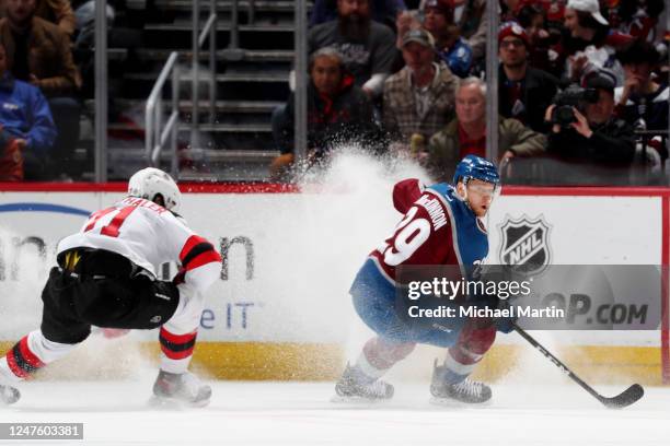 Nathan MacKinnon of the Colorado Avalanche skates against Jonas Siegenthaler of the New Jersey Devils at Ball Arena on March 1, 2023 in Denver,...