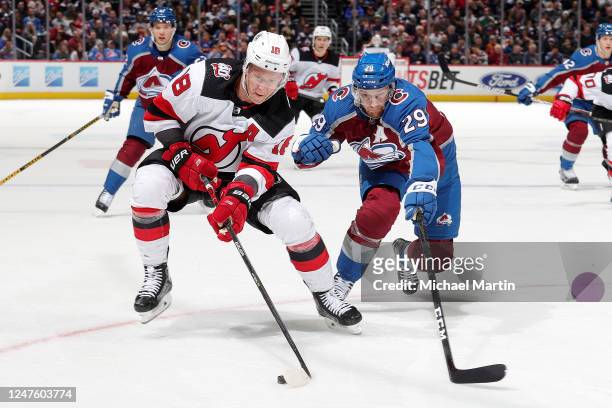 Ondrej Palat of the New Jersey Devils skates against Nathan MacKinnon of the Colorado Avalanche at Ball Arena on March 1, 2022 in Denver, Colorado.