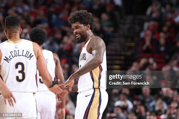 McCollum of the New Orleans Pelicans high fives Naji Marshall during the game against the Portland Trail Blazers on March 1, 2023 at the Moda Center...