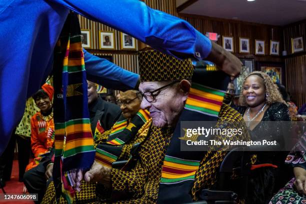 Dr. Ibrahim Mohammed Awal, Minister of Tourism, Arts, and Culture of Ghana, drapes Kente cloth around the neck of Hughes Van Ellis during a...