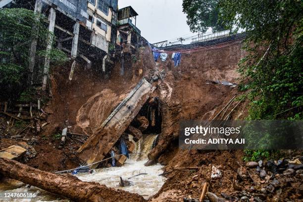 The foundation of a building on the edge of the ravine is seen following a landslide caused from heavy rains in the Caringin area, in Bogor on March...