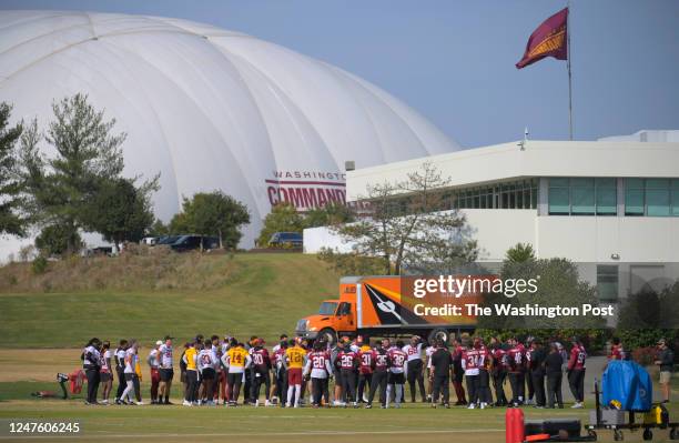 Commanders gather around Washington Commanders head coach Ron Rivera as practice begins at the Washington Commanders training facility on November 2,...