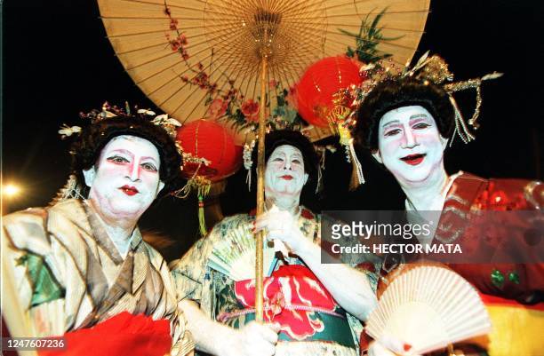 Three men disguised as Japanese "geishas" walk on the streets of West Hollywood during a Halloween extravaganza late 31 October. The town has claimed...