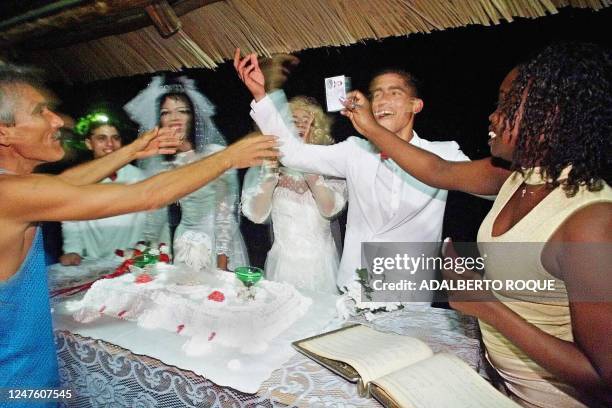 By MARIE SANZ. A relative congratulates transvestites Angel and Juanito , dressed in wedding dresses, after recieving unexpected approval of judge of...