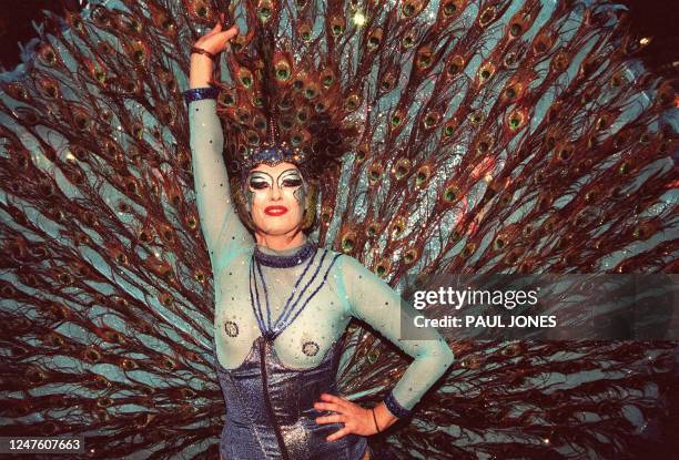 Woman shows of her feathers with the Goddess of the night float during the 23rd Sydney Gay and Lesbian Mardi Gras Parade 04 March 2000. It was...