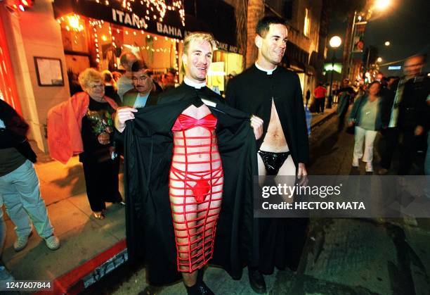 Couple of gay men disguised as priests stand in the streets of West Hollywood 31 October during a Halloween extravaganza. The city claims to hold the...