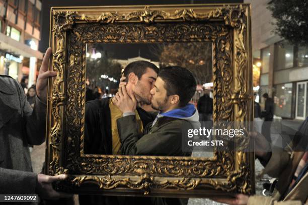 Gay couple kisses on February 14, 2011 during a protest against the Greek state's refusal to recognise same-sex marriages on Athens' Ermou St, the...