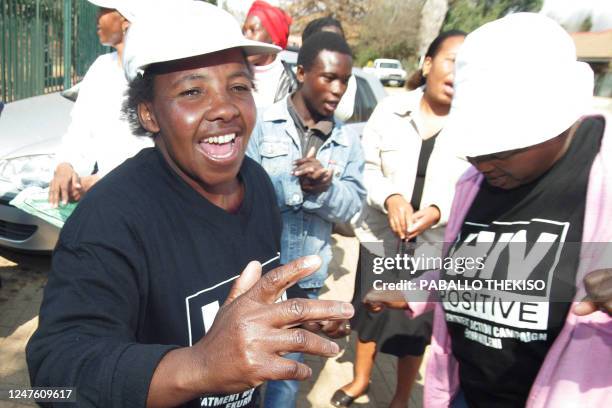 Human rights activists and supporters of the killed former South African national football team striker Eudy Simelane dance on August 27, 2009...