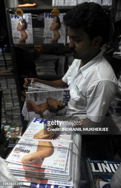 Bookstore employee counts copies of the FHM magazine upon delivery in Mumbai on December 5, 2011. India's version of FHM magazine has defended the...