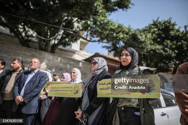 Palestinians, holding banners and photos of Palestinian prisoner, gather to stage protest to show solidarity with Palestinian prisoner in Israeli...