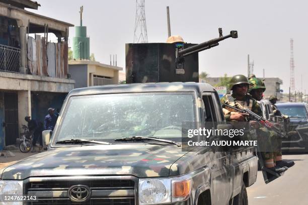 Members of the Nigerian Army are seen during a visit by Nigerian President Muhammadu Buhari to the Maiduguri Monday Market on March 2 after the...